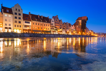 Fototapeta na wymiar The old town of Gdansk at frozen Motlawa river, Poland