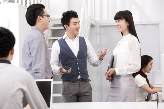 Cheerful businessman introduce his friend to colleague