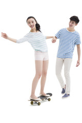 Fototapeta premium Young man teaching his girlfriend to skateboard