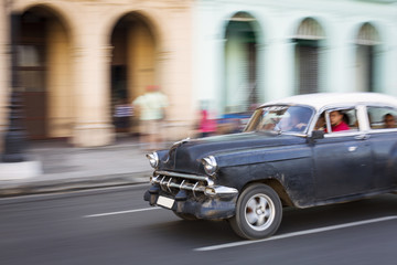 Panning with old car on streets of Havana, Cuba