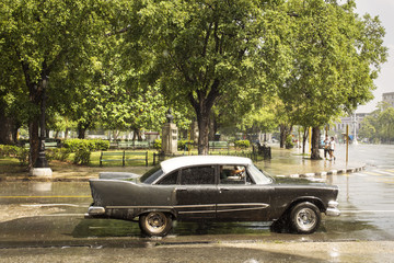 Old car on street of Havana, Cuba on the rainy day