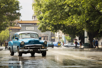 Old car on street of Havana, Cuba on the rainy day