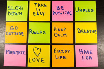 slow down, relax, take it easy, keep calm, love, enjoy life, have fun and other motivational lifestyle reminders on colorful sticky notes - obrazy, fototapety, plakaty