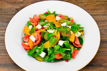Healthy and Diet Food: Salad, Persimmon, Pickled Cucumber, Tomat