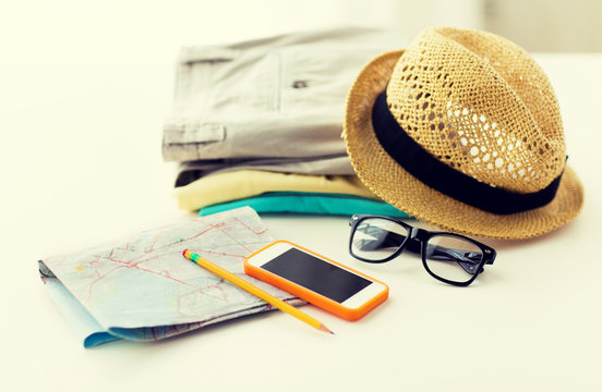 close up of summer clothes and travel map on table