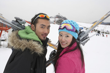 Couple On Ski Field, Holding Skis