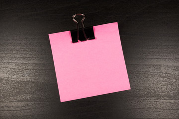 Sticky note on wooden background, empty space for text