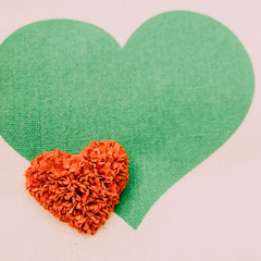 Fototapeta na wymiar Red hearts and green heart white background.