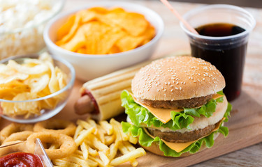 close up of fast food snacks and drink on table
