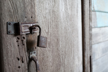 Old rusty locks on wooden door