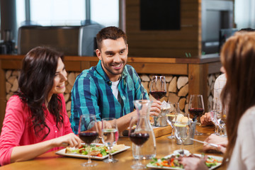 friends dining and drinking wine at restaurant