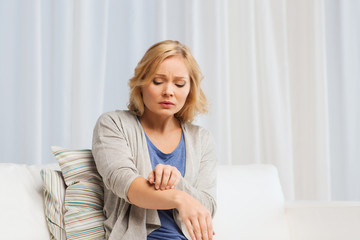 unhappy woman suffering from hand inch at home