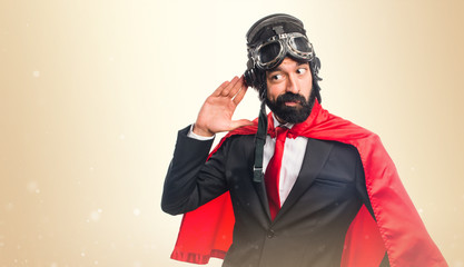 Super hero businessman listening something © luismolinero