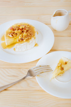 Camembert cheese with honey sauce with nuts and butter