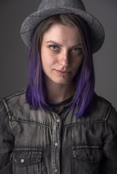 Violet haired gothic girl posing in studio