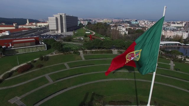 Portuguese Waving Flag on top of the Eduardo VII Park in Lisbon, Portugal