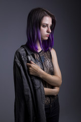 Violet haired gothic girl posing in studio