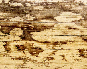 Weathered wood painted pale yellow.