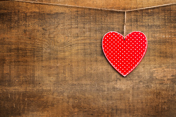 Red heart hanging on the clothesline for Valentine Day