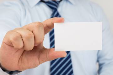 Man hand holding a business card