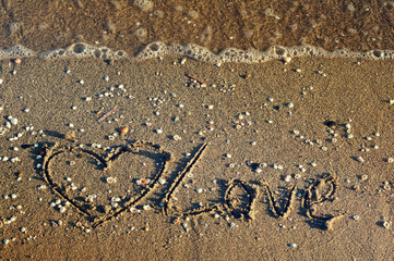 Fototapeta na wymiar Love you handwritten in sand for natural, love,tourism or conceptual designs. Honeymoon or valentine's day greetings on the sand.