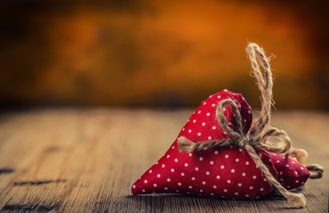 Valentines day. Wedding day. Red cloth handmade hearts on wooden background - table. Free space for your love text.