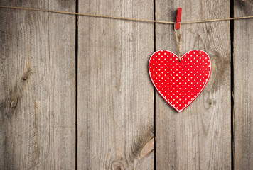 Red heart hanging on the clothesline for Valentine Day