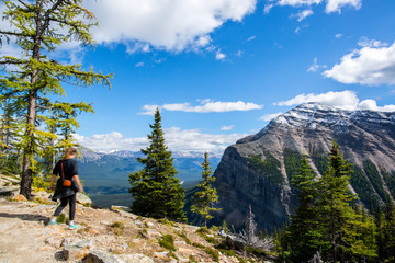 Fototapeta na wymiar girl walking on a summit of a mountain in the banff national park in alberta canada close to lake louise
