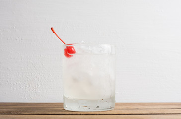 Old fashioned cocktail with cherry