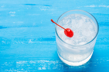 Old fashioned cocktail with cherry