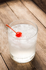 Old fashioned cocktail with cherry