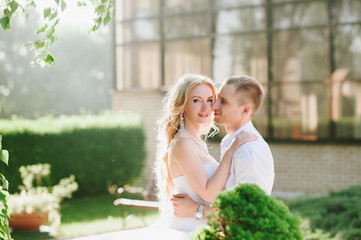 Naklejka premium Sensual embrace bride and groom in the light of sunset, relationships, family, wedding