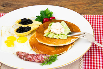 Pancakes with Quail Eggs, Cold Meats, Pastry Spoon with Black Ca