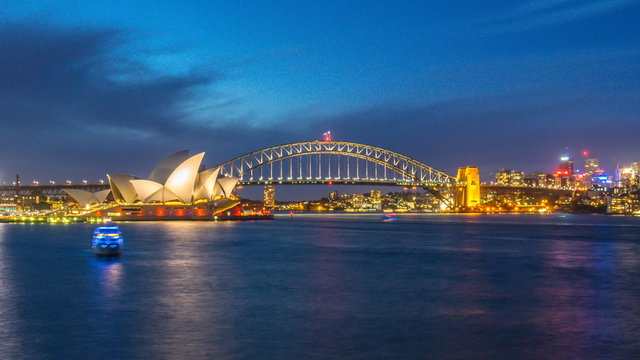 4k footage time lapse of day to night blue hour at Sydney Opera House, view from Royal Botanic Gardens. Panning