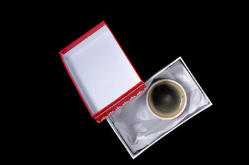 a cup of coffee in a gift box