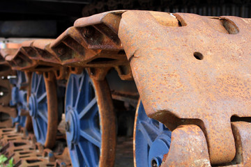 The old rusty caterpillar of the crawler tractor