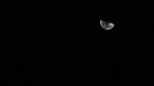 clouds Moving Across Face Of Half Moon