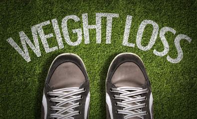 Top View of Sneakers on the grass with the text: Weight Loss
