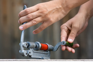 hands reloading cartridge by shotgun shell reloader, closeup