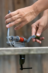 hands reloading shotgun cartridge