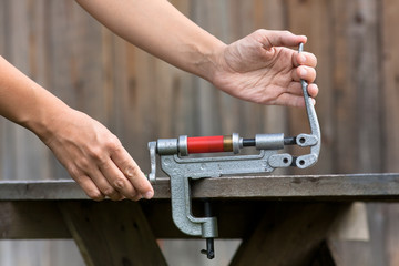 reloading cartridge by shotgun shell reloader, closeup