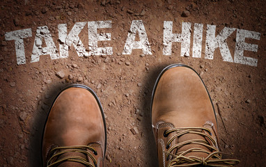 Top View of Boot on the trail with the text: Take a Hike