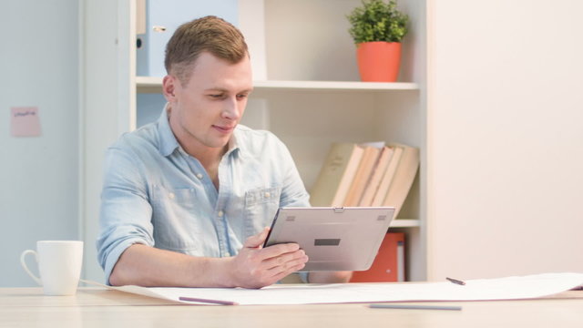 Male office worker is busy at the office.