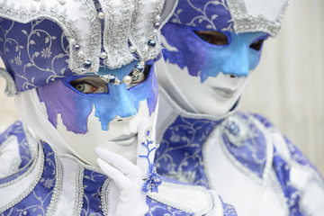 Masked man and woman with blue dress