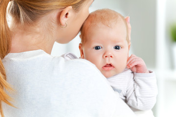 newborn baby in embrace of mother