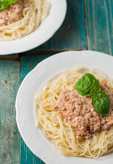 Spaghetti with sauce on blue wooden background
