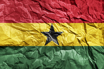 Ghana flag painted on crumpled paper background