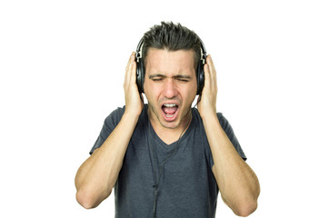 Man scream while listening music with his headphones - people and technology concept - caucasian people