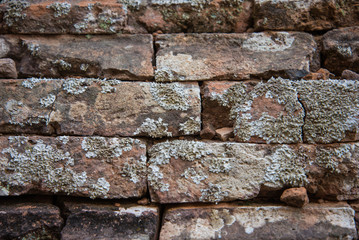 Old and broken red stone brick wall