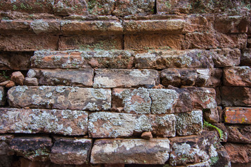 Old and broken red stone brick wall